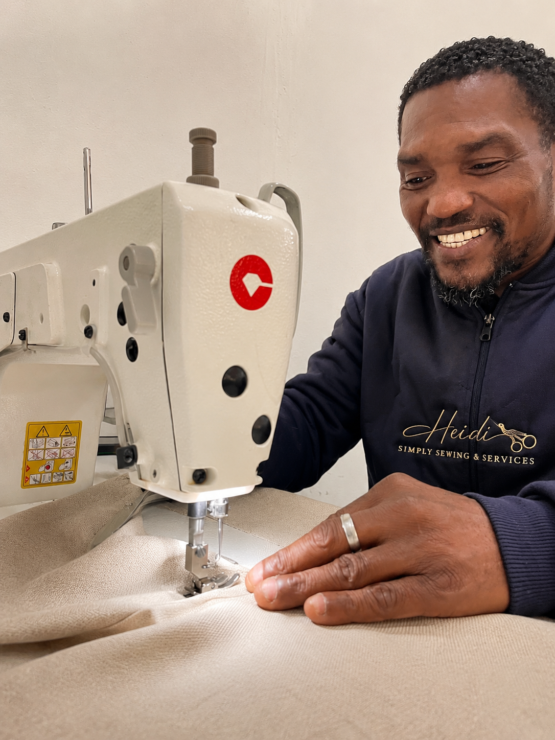 Team member at the studio sewing machine