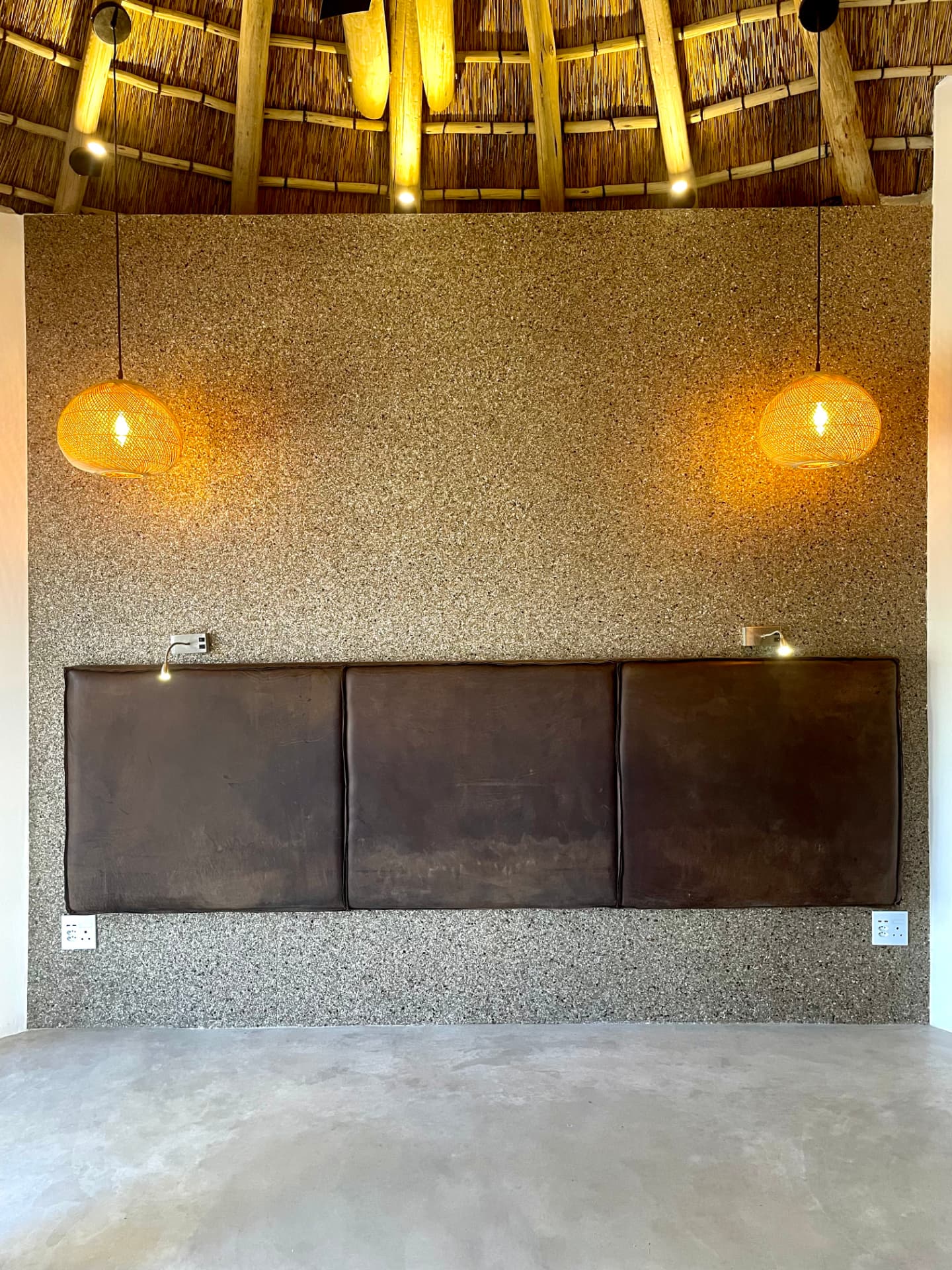 Leather upholstered wall-mounted headboard