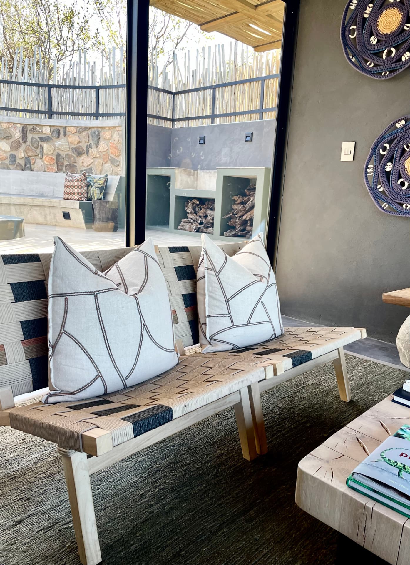 Embroidered linen cushions on woven bench